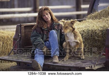 Stock Photo - people, woman, dog, hay, pet, straw. Fotosearch