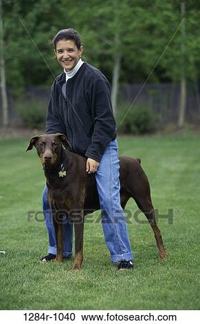 Stock Image - people, woman, dog, Hispanic, pet, outdoors, brunette. Fotosearch