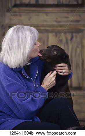 Stock Image - people, woman, dog, senior, pet, tongue, affection. Fotosearch