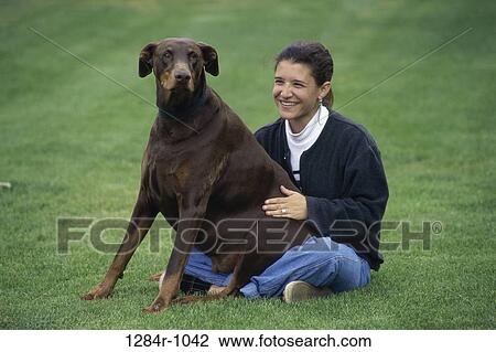 Stock Image - people, woman, dog, sitting, Hispanic, pet. Fotosearch