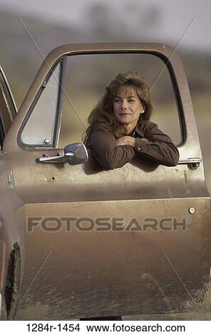 people, woman, door, car, leaning, outdoors, transportation View Large Photo Image Picture - people, woman, door, car, leaning, outdoors, transportation. Fotosearch