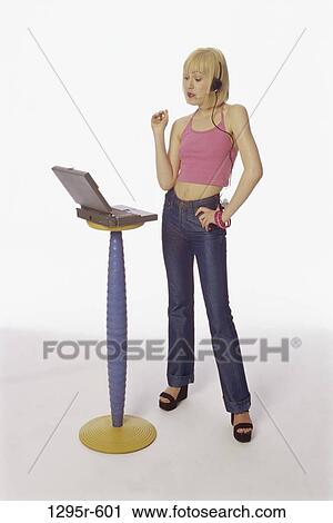 Stock Image - people, woman, headset, computer, laptop, pedestal, blond. Fotosearch