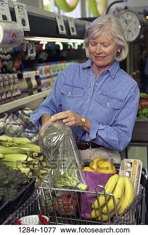 Stock Photo - people, woman, produce, senior, bag, shopping, cart. Fotosearch