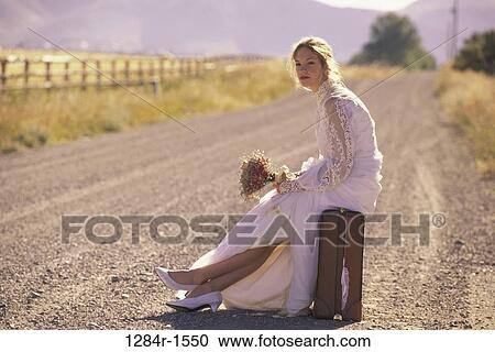 Stock Image - people, woman, road, sitting, outdoors, blond. Fotosearch