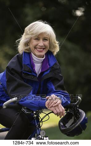 people, woman, senior, bicycle, helmet, outdoors, turtleneck View Large Photo Image Picture - people, woman, senior, bicycle, helmet, outdoors, turtleneck. Fotosearch