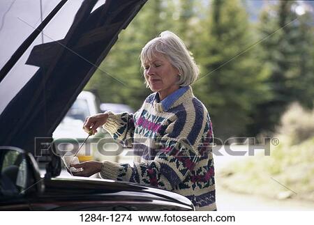 people, woman, senior, car, sweater, oil View Large Photo Image Picture - people, woman, senior, car, sweater, oil. Fotosearch