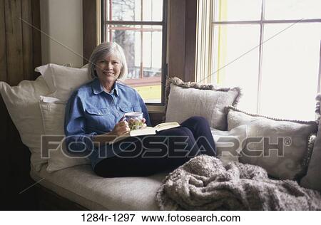 people, woman, senior, reading, drinking, relaxing, indoors View Large Photo Image Stock Photo - people, woman, senior, reading, drinking, relaxing, indoors. Fotosearch