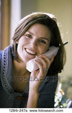 Stock Image - people, woman, telephone, talking, phone, Middle-aged, brunette. Fotosearch