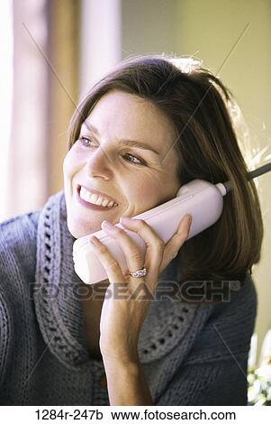 Stock Image - people, woman, telephone, talking, phone, Middle-aged, brunette. Fotosearch