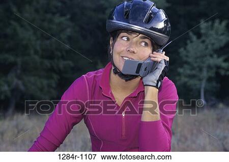 Stock Photo - people, woman, telephone, talking, phone, bicycle. Fotosearch
