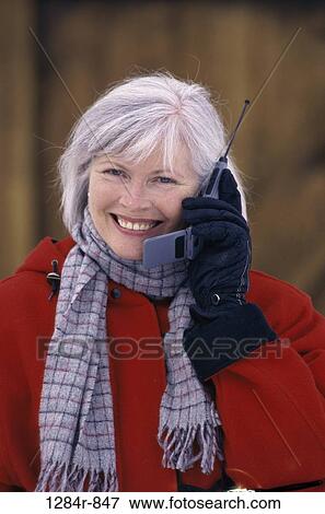 Stock Photo - people, woman, telephone, talking, senior, winter, phone. Fotosearch