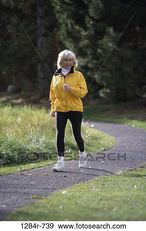 people, woman, walking, senior, brisk, outdoors, path View Large Photo Image Stock Photo - people, woman, walking, senior, brisk, outdoors, path. Fotosearch