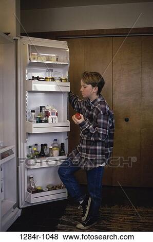 Stock Photo - plaid, open, boy, holding, refrigerator, apple. Fotosearch