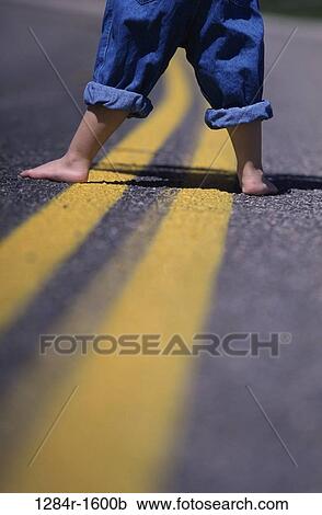 Stock Image - road, street, body parts, feet, jeans, denim. Fotosearch