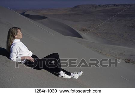 Stock Image - sand, people, woman, desert, outdoors, relaxing. Fotosearch