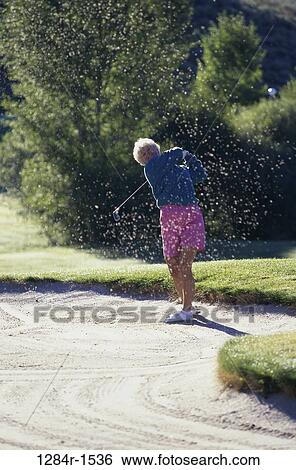 sand, people, woman, golf, senior, swinging, swing View Large Photo Image Stock Photograph - sand, people, woman, golf, senior, swinging, swing. Fotosearch