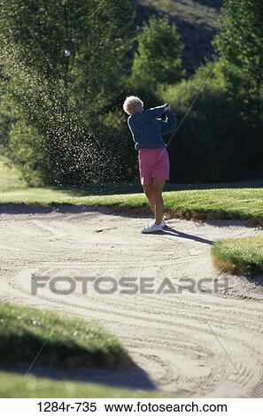 Stock Photography - sand, people, woman, golf, senior, swinging, swing. Fotosearch