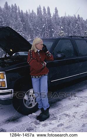 Stock Image - snow, woman, telephone, car, winter, phone, broken. Fotosearch