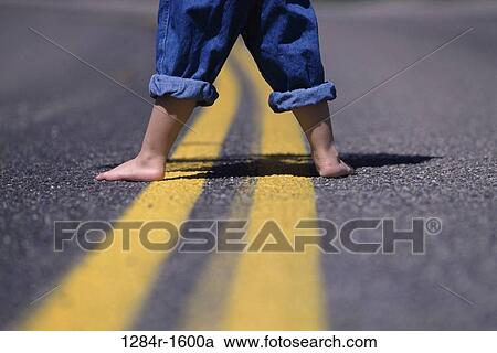 Stock Image - street, body parts, barefoot, feet, jeans, lines. Fotosearch