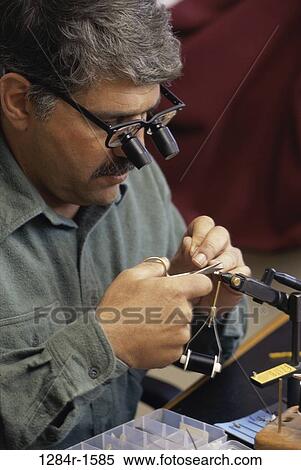 Stock Photography - tie, magnifying, eyeglasses, Hispanic, sports, Middle-aged. Fotosearch