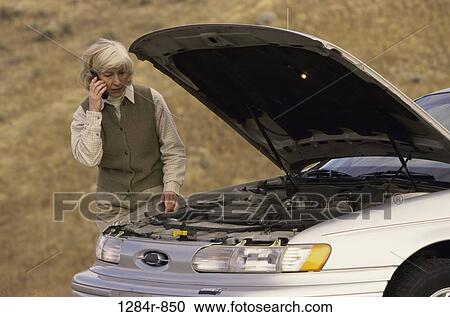 Stock Image - woman, car, outdoors, transportation, engine, hood. Fotosearch