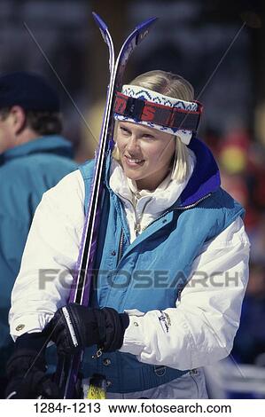 Stock Image - woman, skiing, outdoors, sports, skis, jacket, blond. Fotosearch