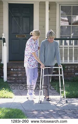 Stock Image - women, walking, patient, nurse, medicine, outdoors, medical. Fotosearch