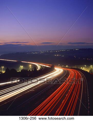 Stock Photograph - dusk, evening, motion, transportation, cars, lights, traffic. Fotosearch