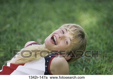 Stock Image - grass, people, braces, girl, outdoors, child. Fotosearch