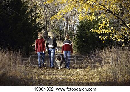Stock Image - people, autumn, walking, dog, pet, outdoors. Fotosearch