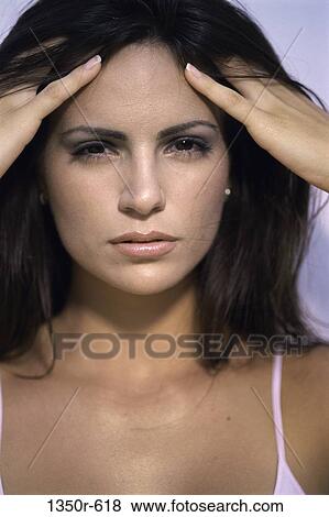 Stock Photo - people, headache, woman, Hispanic, hair, stress, health. Fotosearch
