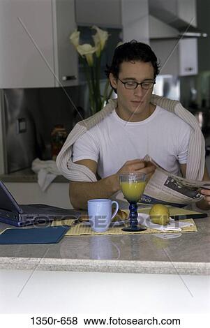 Stock Photo - people, newspaper, eyeglasses, reading, laptop, breakfast. Fotosearch