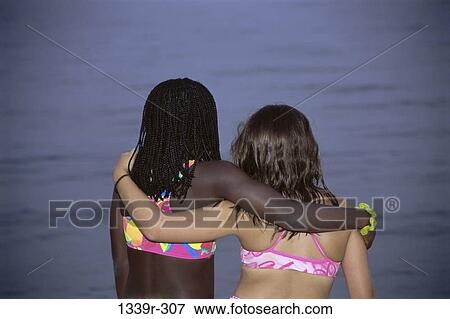 people, reflection, water, friendship, beach, outdoors, hugging View Large Photo Image Stock Photo - people, reflection, water, friendship, beach, outdoors, hugging. Fotosearch