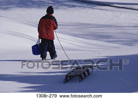 people, snow, winter, boy, outdoors, pulling View Large Photo Image Stock Photo - people, snow, winter, boy, outdoors, pulling. Fotosearch