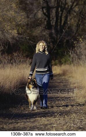 people, woman, autumn, walking, dog, pet, outdoors View Large Photo Image Stock Image - people, woman, autumn, walking, dog, pet, outdoors. Fotosearch