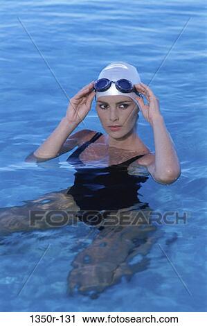 Stock Image - people, woman, beach, sports, cap, goggles. Fotosearch