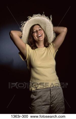 Stock Image - people, woman, smiling, hat, laughing, holding, standing. Fotosearch