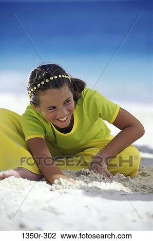 Stock Image - sand, people, playing, beach, girl, child, digging. Fotosearch