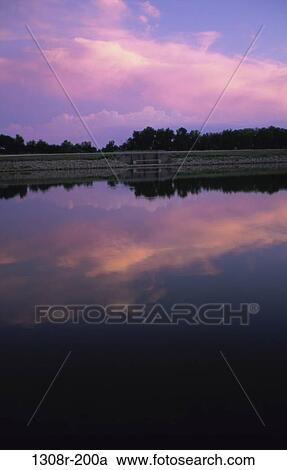 Stock Image - sky, reflection, water, clouds, sunset, still, lake. Fotosearch