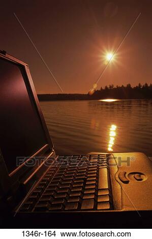 water, sun, orange, computer, laptop, sunset View Large Photo Image Picture - water, sun, orange, computer, laptop, sunset. Fotosearch