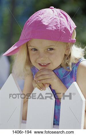 Picture - fence, people, smiling, girl, outdoors, smile, child. Fotosearch