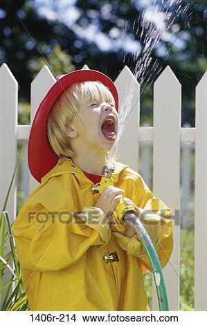 fence, people, water, playing, hat, spraying, playful View Large Photo Image Picture - fence, people, water, playing, hat, spraying, playful. Fotosearch