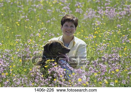 Field, people, woman, dog, pet, flowers View Large Photo Image Stock Photograph - Field, people, woman, dog, pet, flowers. Fotosearch