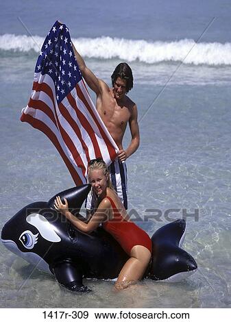 people, American, water, couple, beach, riding, playful View Large Photo Image Stock Photo - people, American, water, couple, beach, riding, playful. Fotosearch