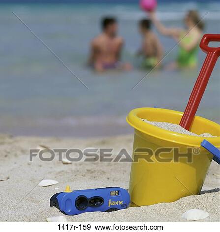 Stock Photo - people, beach, family, toy, bucket. Fotosearch