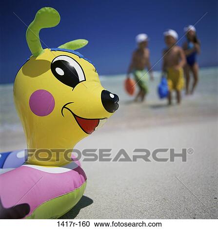 Stock Image - people, beach, raft, friends, toy. Fotosearch