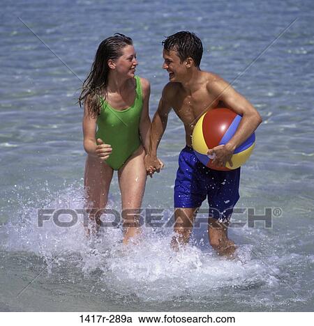 people, couple, beach, beach ball, brunette View Large Photo Image Stock Image - people, couple, beach, beach ball, brunette. Fotosearch