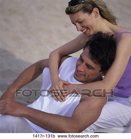 Stock Image - people, couple, beach, chairs, embracing, embrace. Fotosearch