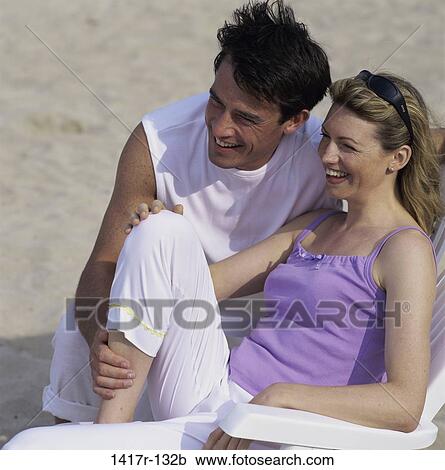 people, couple, beach, looking, chairs, touching View Large Photo Image Stock Image - people, couple, beach, looking, chairs, touching. Fotosearch