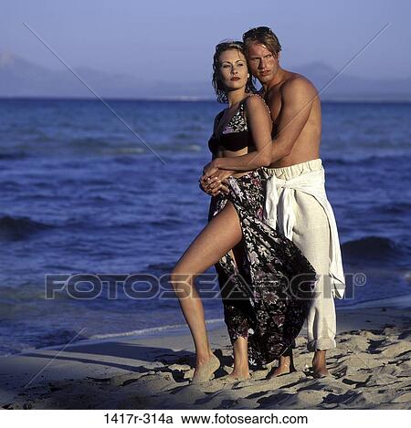 Stock Image - people, couple, beach, romantic, hugging, shore, square. Fotosearch